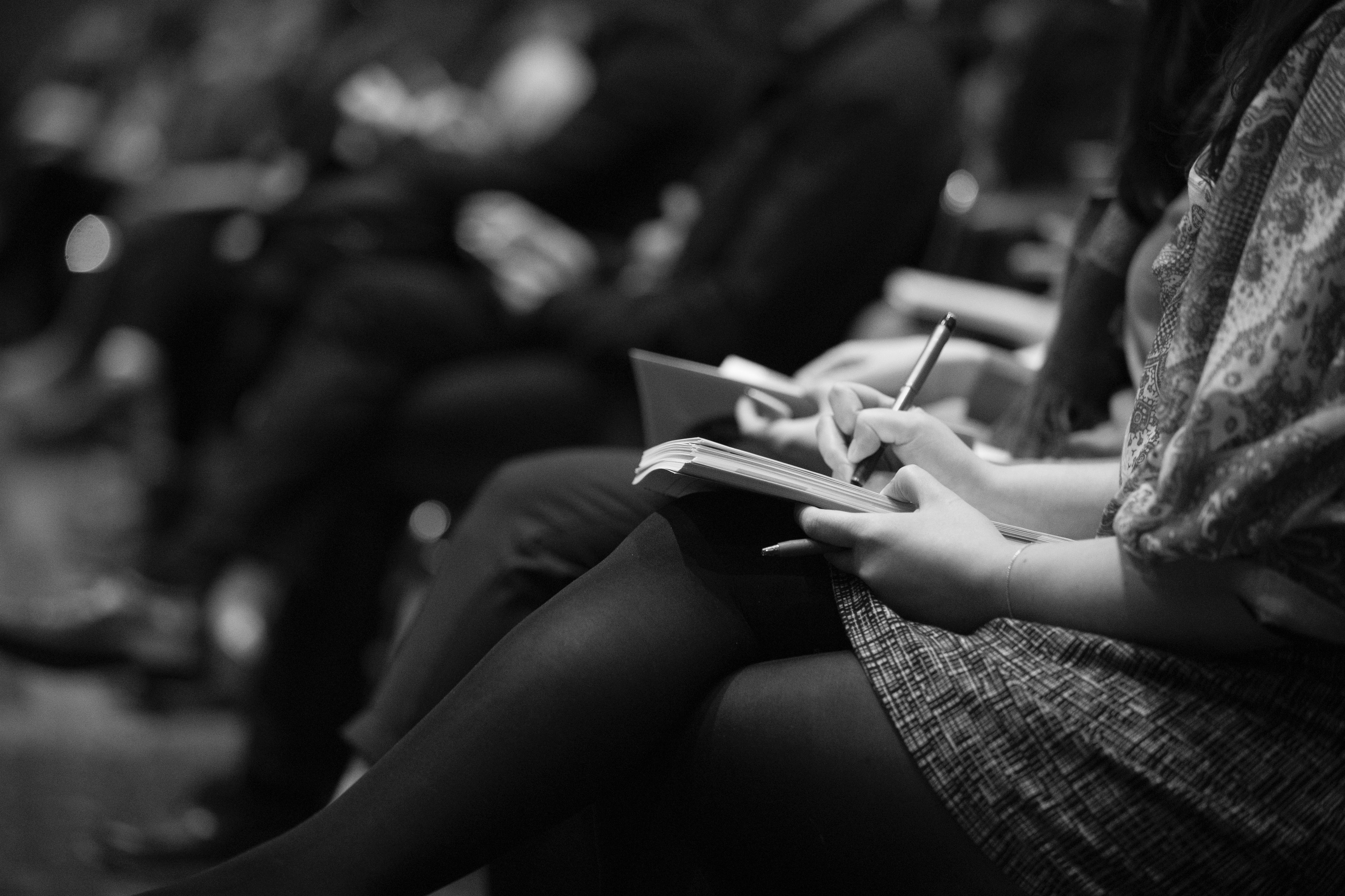 Journalists taking notes during press conference
